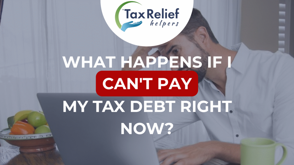 A stressed-out man doing his taxes on a laptop.